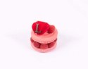 Rose flavoured macaron filled with rose petal and raspberry